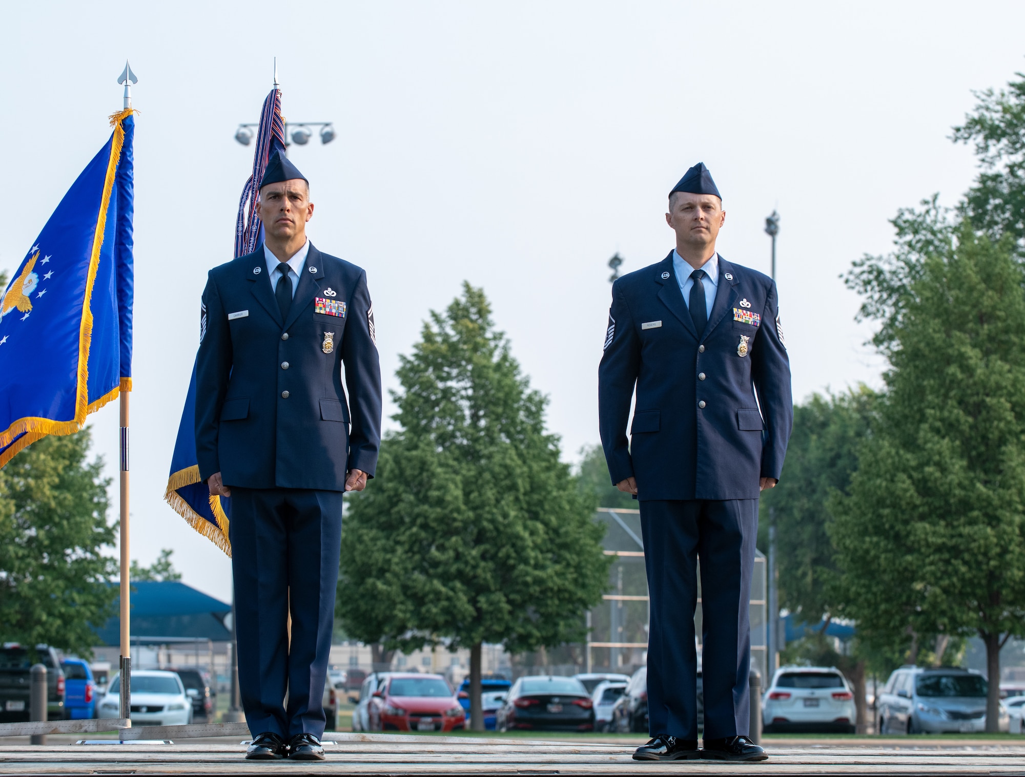 U.S. Air Force Senior Master Sgt. Chad Carrier (left) and Master Sgt. Justin Rogers, 419th Civil Engineer Squadron, stand at attention during a ceremony where they were awarded the Airman’s Medal at Hill Air Force Base, Utah on July 11, 2021. Carrier and Rogers displayed exemplary heroism actions when they saved the life of a trapped driver by pulling him from a burning vehicle.