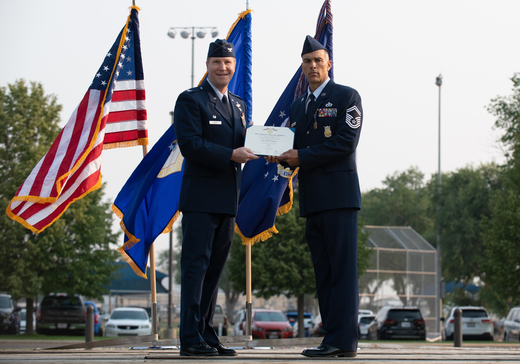 U.S. Air Force Senior Master Sgt. Chad Carrier, 419th Civil Engineer Squadron, receives the Airman’s Medal from Col. Matthew Fritz, 419th Fighter Wing commander, during a ceremony at Hill Air Force Base, Utah on July 11, 2021. Carrier displayed exemplary heroism actions when he saved the life of a trapped driver by pulling him from a burning vehicle.