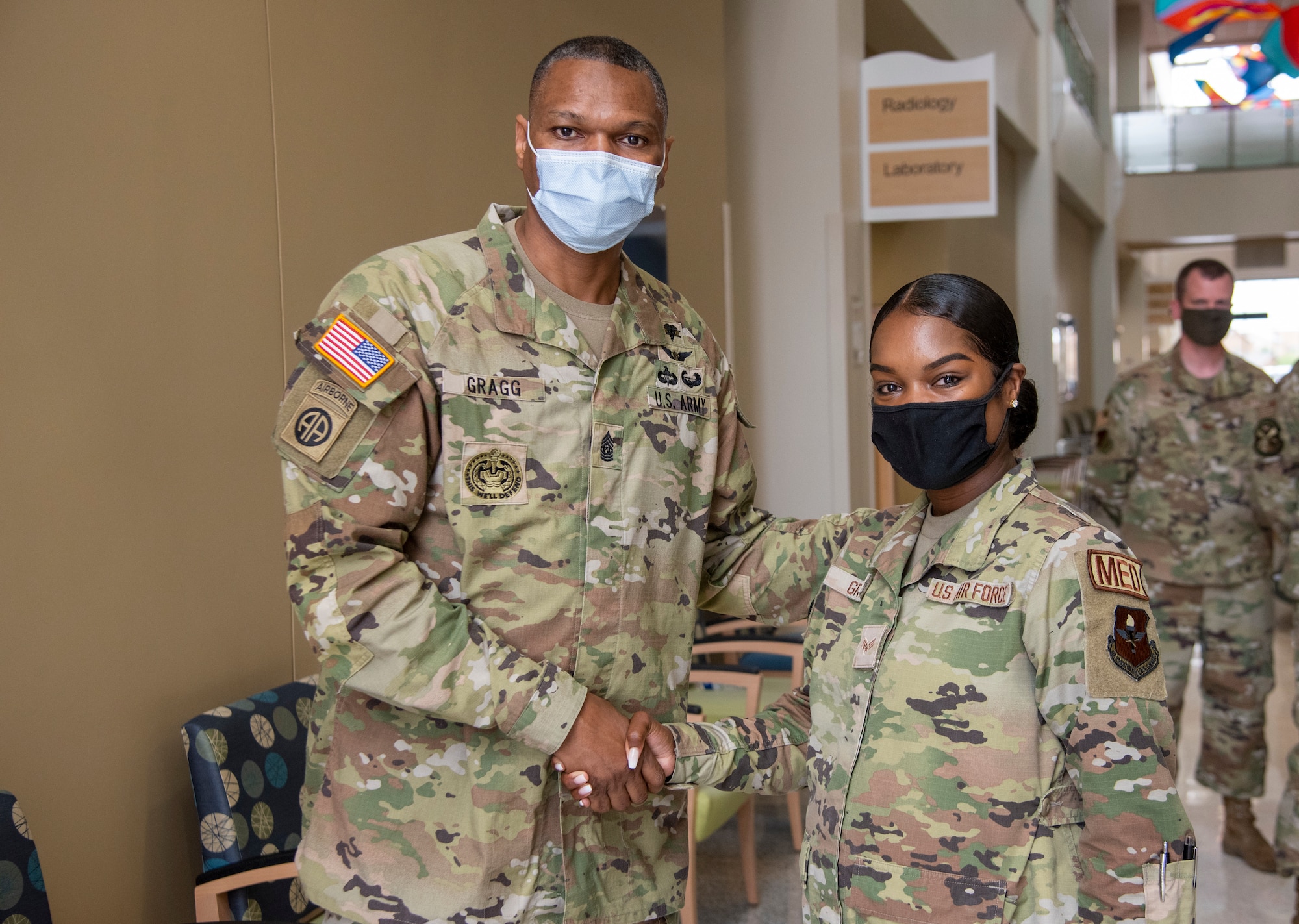 Command Sgt. Maj. Michael Gragg, Defense Health Agency senior enlisted leader, poses for a photo after coining Senior Airman Briannah Grant, 49th Medical Group operational medicine medical technician, June 30, 2021, on Holloman Air Force Base, New Mexico. Gragg visited the 49th MDG to discuss the current state of the DHA and to address any areas of concern. (U.S. Air Force photo by Airman 1st Class Jessica Sanchez)