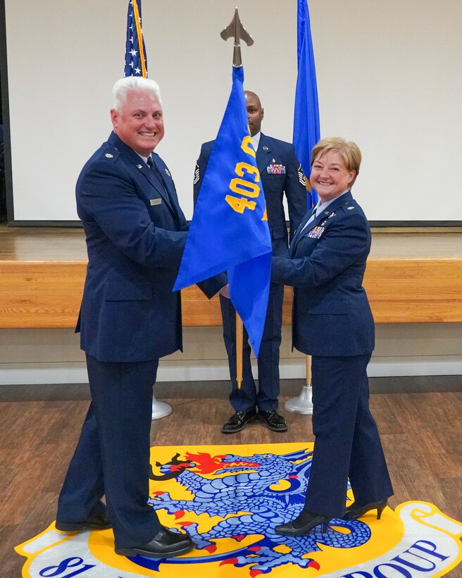 Lt. Col. Shane M. Devlin, 403rd Operations Group deputy commander, hands the guidon to Lt. Col. LaDonna K. Schreffler, 36th Aeromedical Evacuation Squadron commander, during the 36th AES assumption of command ceremony July 10, 2021 at Keesler Air Force Base, Miss. The 36th AES mission is to provide critical care in the air in cases where the patient needs to be transported from an environment with insufficient medical care available, to a hospital. (U.S. Air Force photo by 2nd Lt. Christopher Carranza)