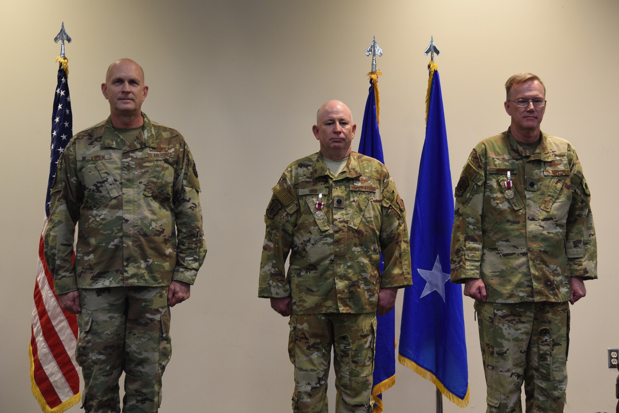 Maj. Gen. Jay Jensen, Air Force Reserve Command Headquarters director of plans, programs and requirements, presided over the retirement ceremony of Lt. Cols. Walter Ord and Timothy Weiher, 815th Airlift Squadron director of operations and assistant DO, respectively, at the Roberts Consolidated Aircraft Maintenance Facility auditorium at Keesler Air Force Base, Miss., July 10, 2021. Ord and Weiher have more than 70 years of combined service, which was recognized during their ceremony. Jensen published the retirement order for both Ord and Weiher after presenting them with Meritorious Service Medals. (U.S. Air Force photo by Master Sgt. Jessica Kendziorek)