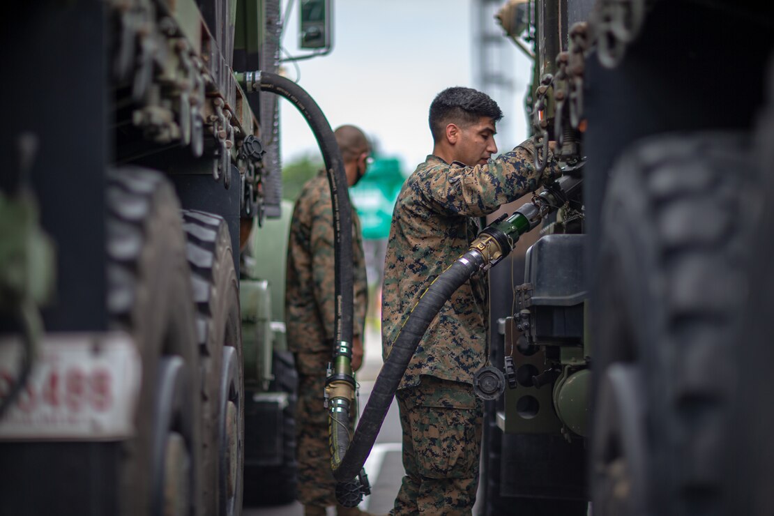 U.S. Marine Corps Staff Sgt. Jesus Alvarado, a motor transport operator with Marine Wing Support Squadron 171, fuels a 7-ton truck during a convoy at a rest stop in Japan, July 10, 2021. U.S. Marines with MWSS-171 began Eagle Wrath 21, a two-week exercise at CATC Camp Fuji to maintain a high level of proficiency and combat readiness.