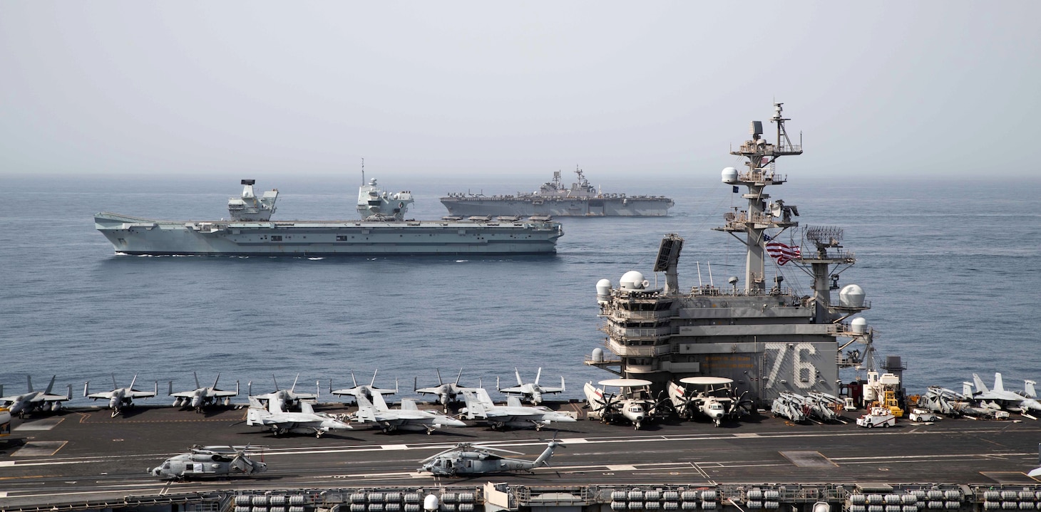 Royal Navy aircraft carrier HMS Queen Elizabeth (R 08), middle, aircraft carrier USS Ronald Reagan (CVN 76) and amphibious assault ship USS Iwo Jima (LHD 7) operate in formation in the Gulf of Aden.