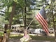 An American flag is displayed at a campsite