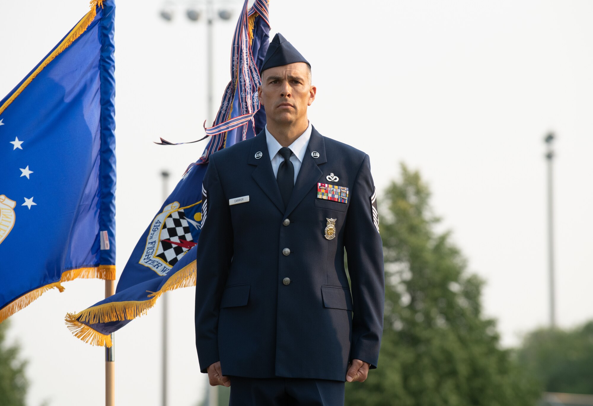 U.S. Air Force Senior Master Sgt. Chad Carrier, 419th Civil Engineer Squadron, stands at attention before being presented the Airman’s Medal at Hill Air Force Base, Utah on July 11, 2021. The Airman’s Medal is a distinguished decoration awarded to those who display heroism or acts of heroism that involve a voluntary risk of life under non-combat conditions.