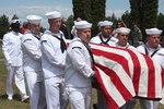 AEKELY, Minn. - (July 10, 2021) Sailors from Navy Operational Support Center Minneapolis carry the remains of USS Oklahoma Sailor Fireman 1st Class Neal Todd during a full military honors funeral. Todd was killed in action aboard USS Oklahoma on Dec. 7, 1941, and his remains were recently identified by the Defense POW/MIA Accounting Agency and returned to Minnesota for burial.  (U.S. Navy Photo by Lt. Cmdr. Michael Sheehan)