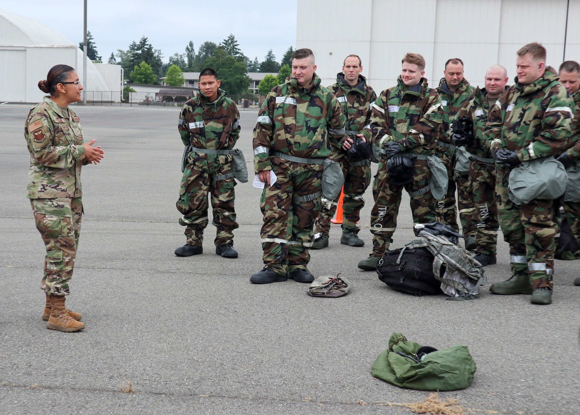 4th AF Command Chief speaks with Airmen in MOPP gear following an exercise.