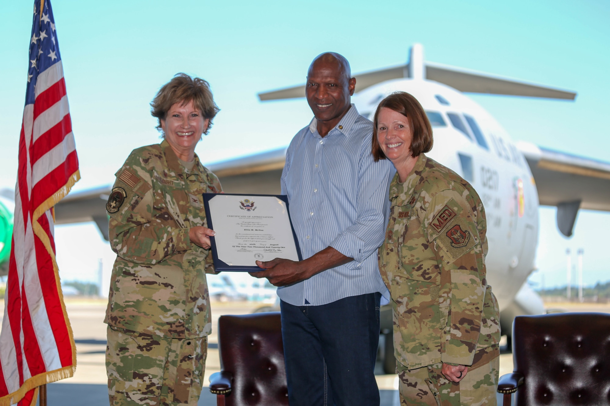 Husband of Chief Master Sgt. Saudi McVea receives certificate of appreciate.