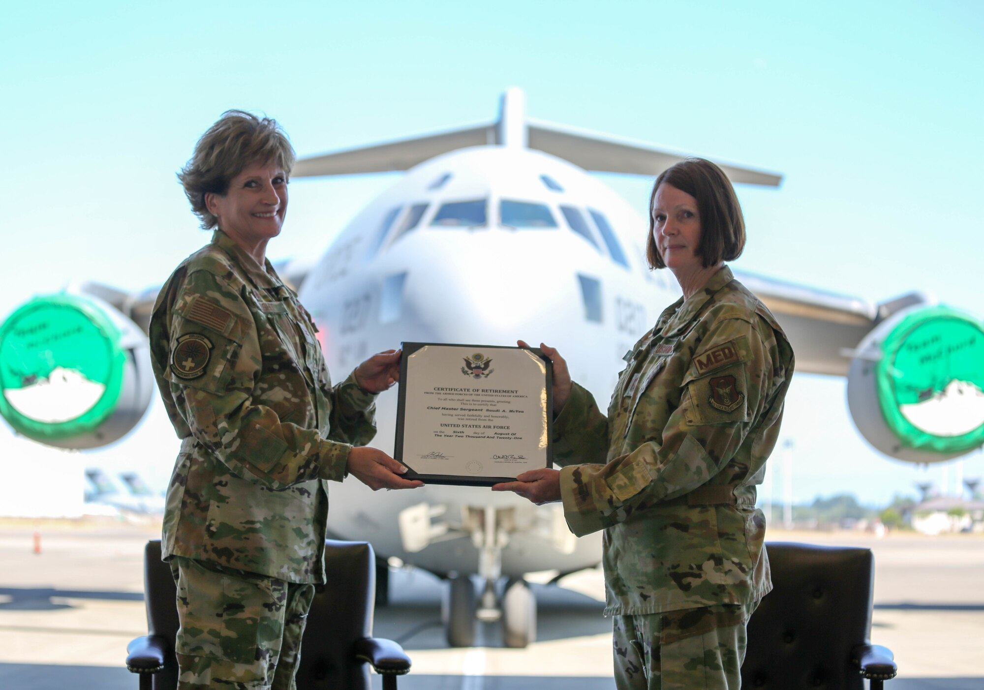 Col Cheryl Knight presents Chief Master Sgt. Saudi McVea with retirement certificate.