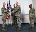 U.S. Air Force Maj. Karl Wiest accepts the guidon from U.S. Air Force Lt. Col. Greg Hignite, Air Force Public Affairs Agency commander, during a change of command ceremony.