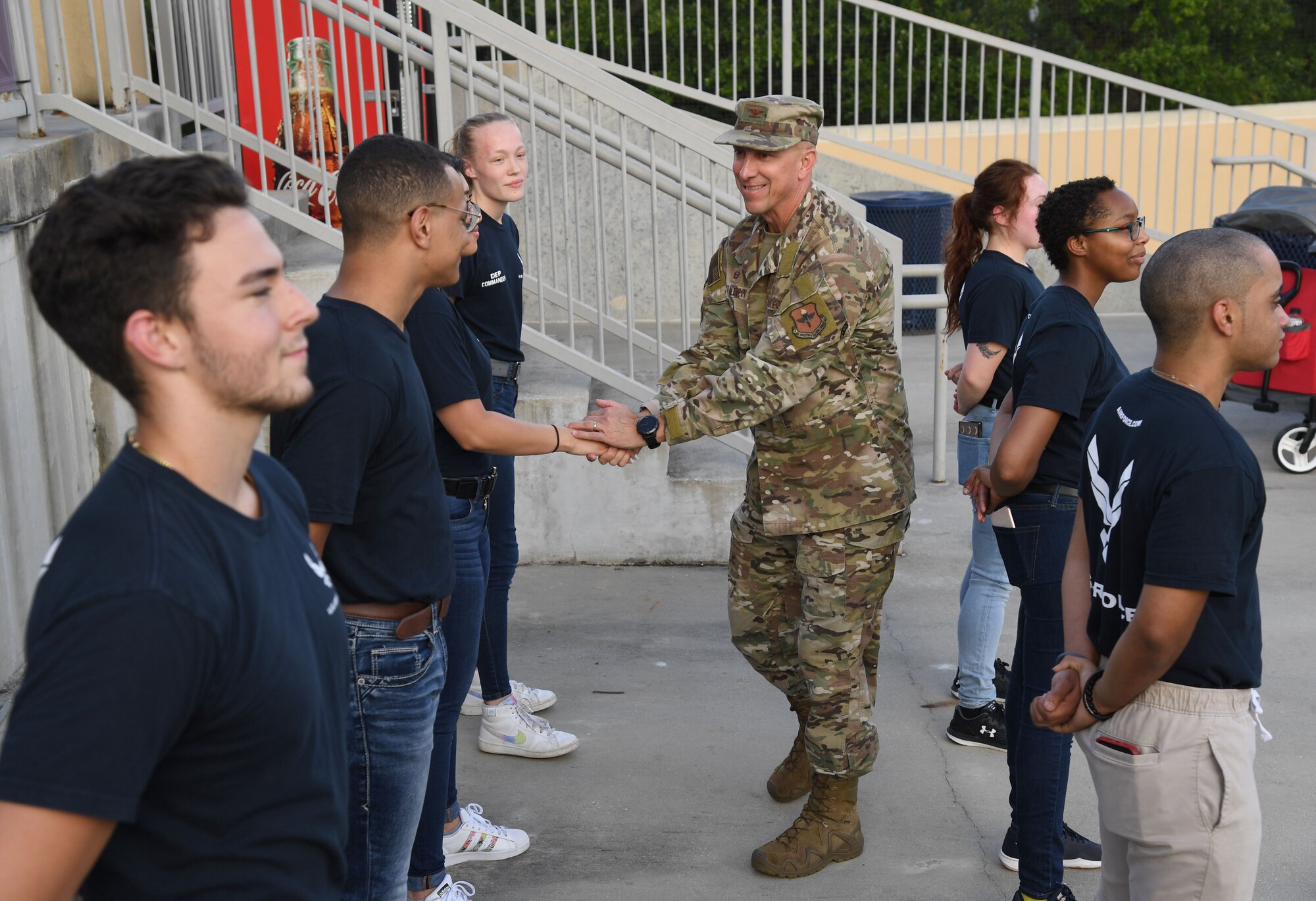 U.S. Air Force Col. William Hunter, 81st Training Wing commander, congratulates 10 Air Force delayed entry program recruits after reciting the oath of office during the Biloxi Shuckers Minor League Baseball game in Biloxi, Mississippi, July 10, 2021. Hunter also threw the first pitch during pre-game festivities. (U.S. Air Force photo by Kemberly Groue)