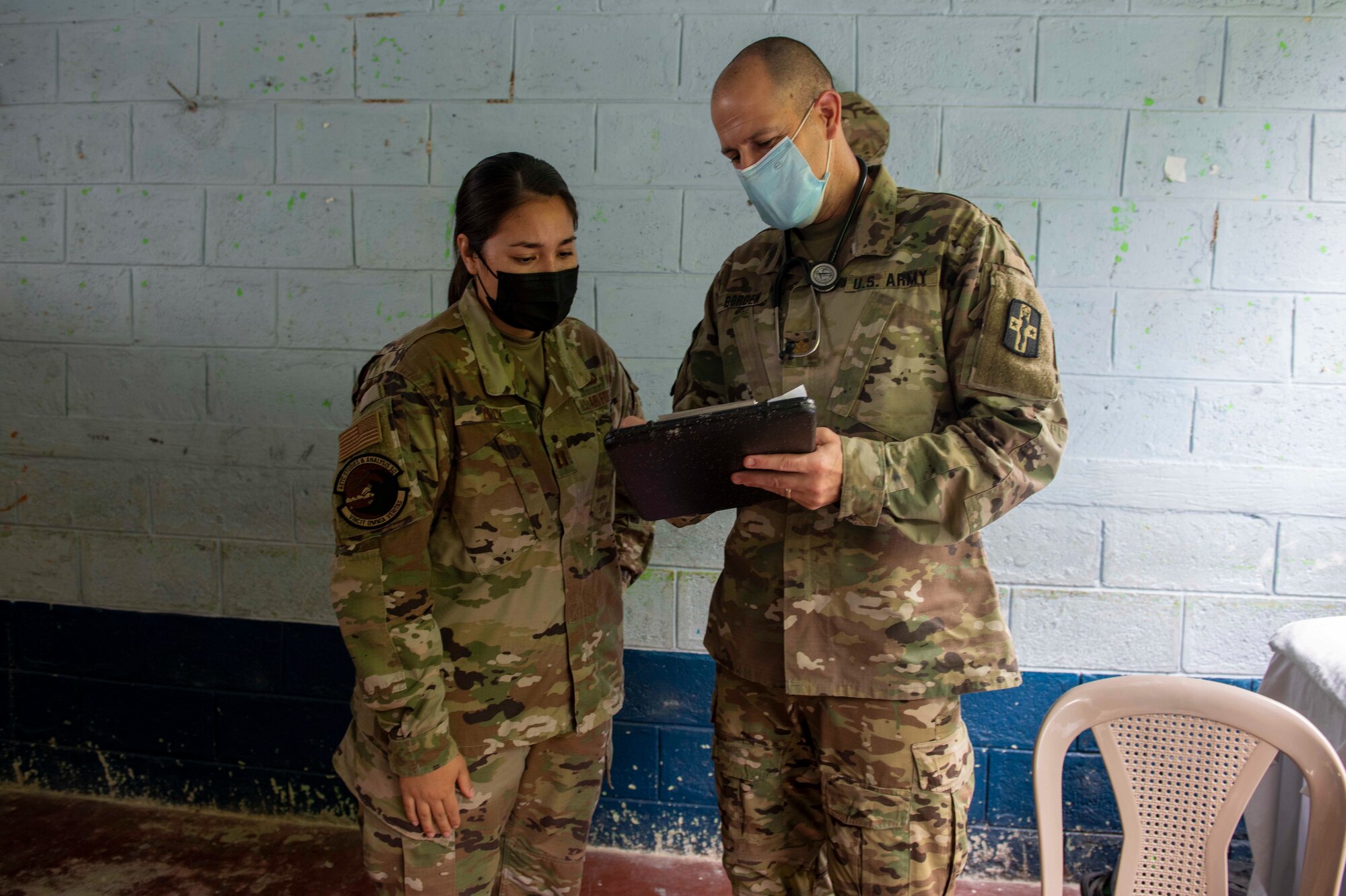 U.S. Air Force Capt. Jennifer Buck, an operations research analyst from the Studies and Analysis Squadron at Joint Base San Antonio-Randolph, Texas, and U.S. Army Maj. Nathan Borden, an emergency medicine M.D., with the 228th Combat Support Hospital of Joint Base San Antonio, Texas, review a patient’s chart during Resolute Sentinel 21 in Melchor De Mencos, Guatemala, June 17, 2021. Buck’s evaluations help account for proper staffing, planning prescription lists, and how to conduct similar missions in the future.