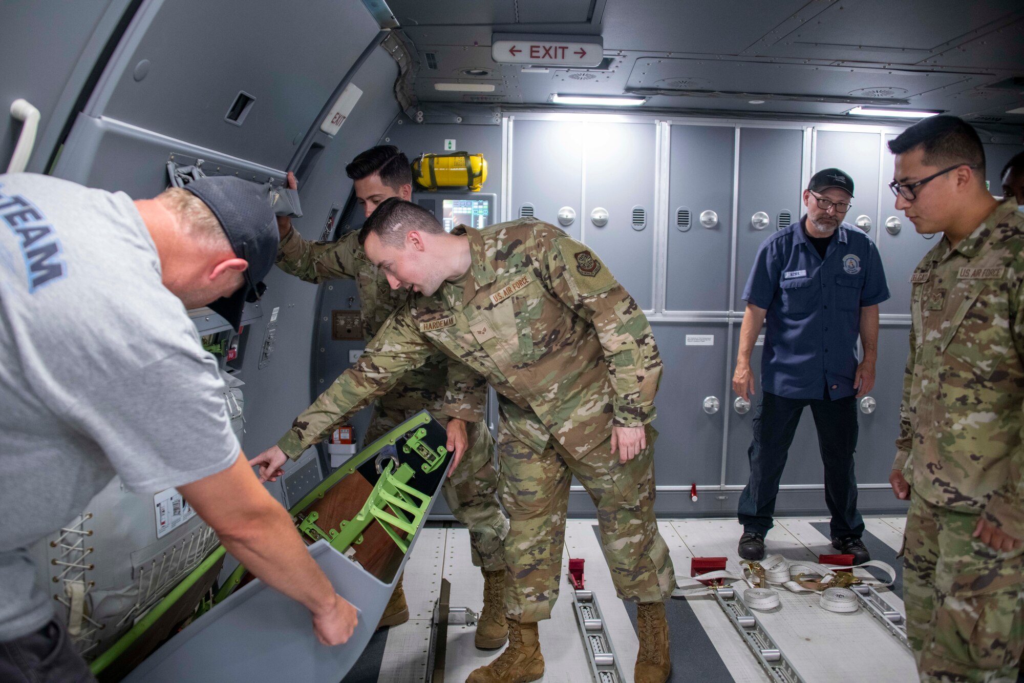 military members inspect an aircraft