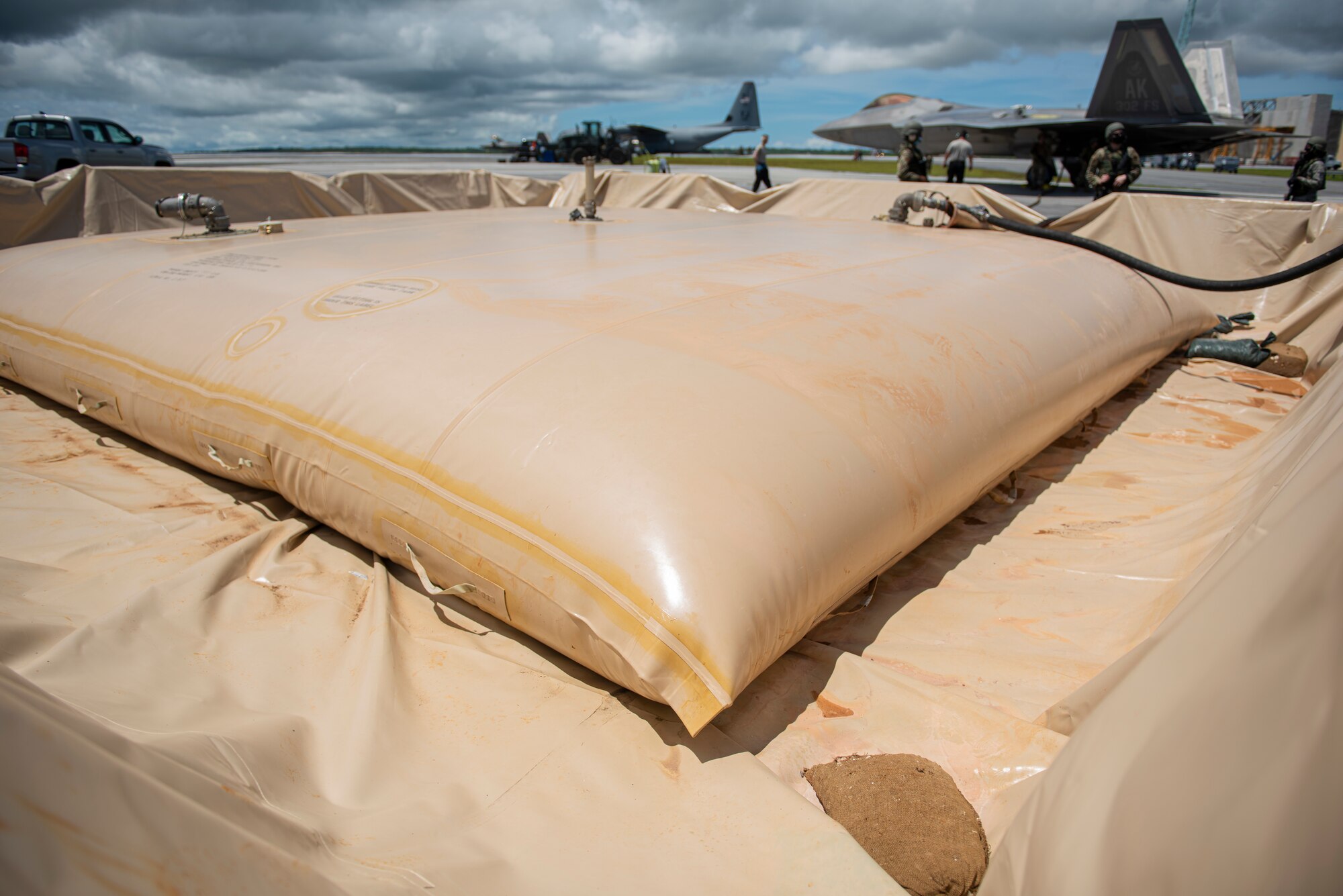 A fuel bladder is shown during a hot refueling of an F-22 Raptor assigned to the 302nd Fighter Squadron, Joint Base Elmendorf-Richardson, Alaska, during exercise Valiant Shield at Andersen Air Force Base, Guam, Sept. 24, 2020. Valiant Shield is a U.S.-only, biennial field training exercise (FTX) with a focus on integration of joint training among U.S. forces in relation to current operational plans. This training enables real-world proficiency in sustaining joint forces through detecting, locating, tracking and engaging units at sea, in the air, on land, and in cyberspace in response to a range of mission areas. ( U.S. Air Force photo by Senior Airman Michael S. Murphy)