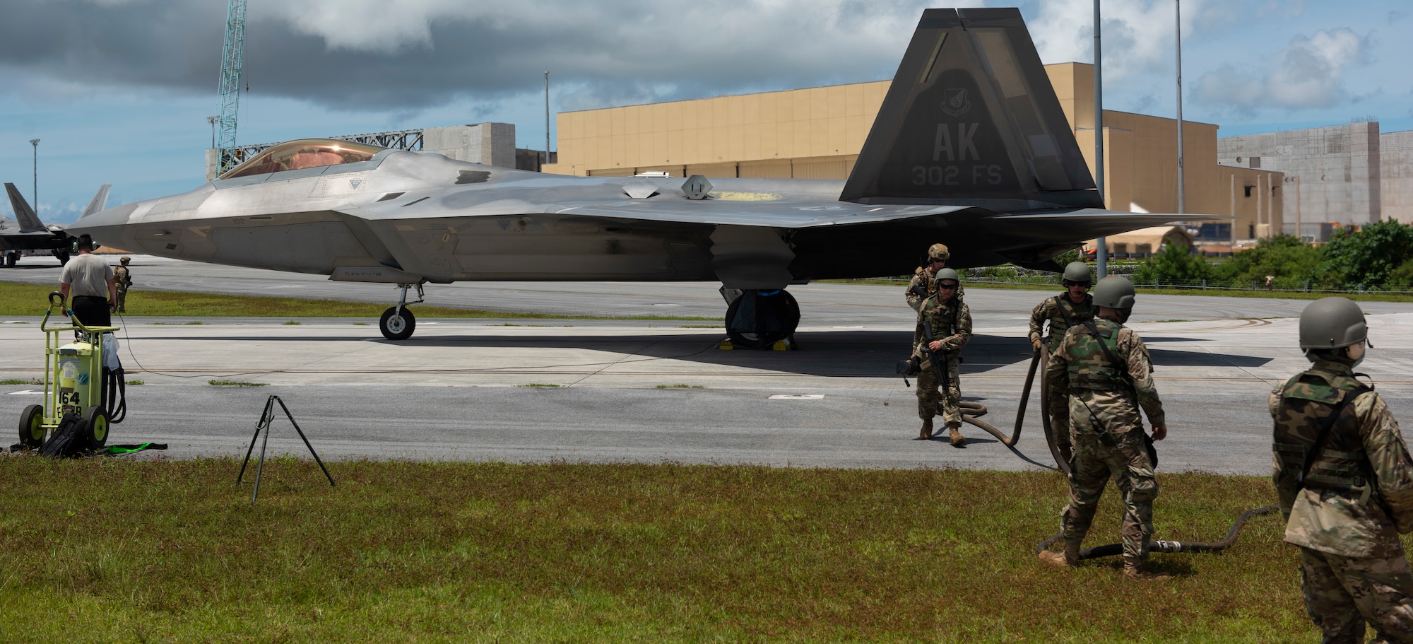 U.S. Air Force Airmen from multiple bases finish a hot refuel for a F-22 Raptor assigned to the 302nd Fighter Squadron, Joint Base Elmendorf-Richardson, Alaska, during exercise Valiant Shield at Andersen Air Force Base, Guam, Sept. 24, 2020. Valiant Shield is a U.S.-only, biennial field training exercise (FTX) with a focus on integration of joint training among U.S. forces in relation to current operational plans. This training enables real-world proficiency in sustaining joint forces through detecting, locating, tracking and engaging units at sea, in the air, on land, and in cyberspace in response to a range of mission areas. ( U.S. Air Force photo by Senior Airman Michael S. Murphy)