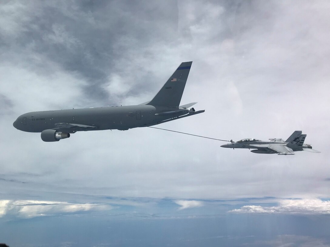NH based KC-46A aircrew refuel a U.S. Navy F/A-18F Super Hornet off the coast of Maryland, July 1, 2020. This marked the first time the aircrew utilized the KC-46A centerline drogue system to refuel an aircraft. (Photo by Lt. Zach Fisher, U.S. Navy)