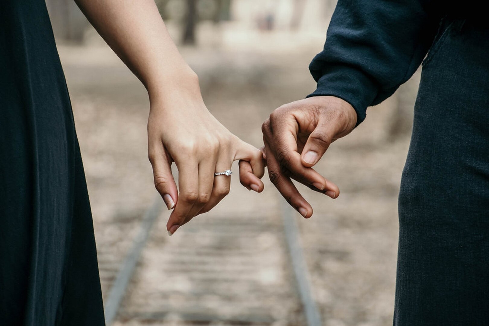 Engaged couple hold hands