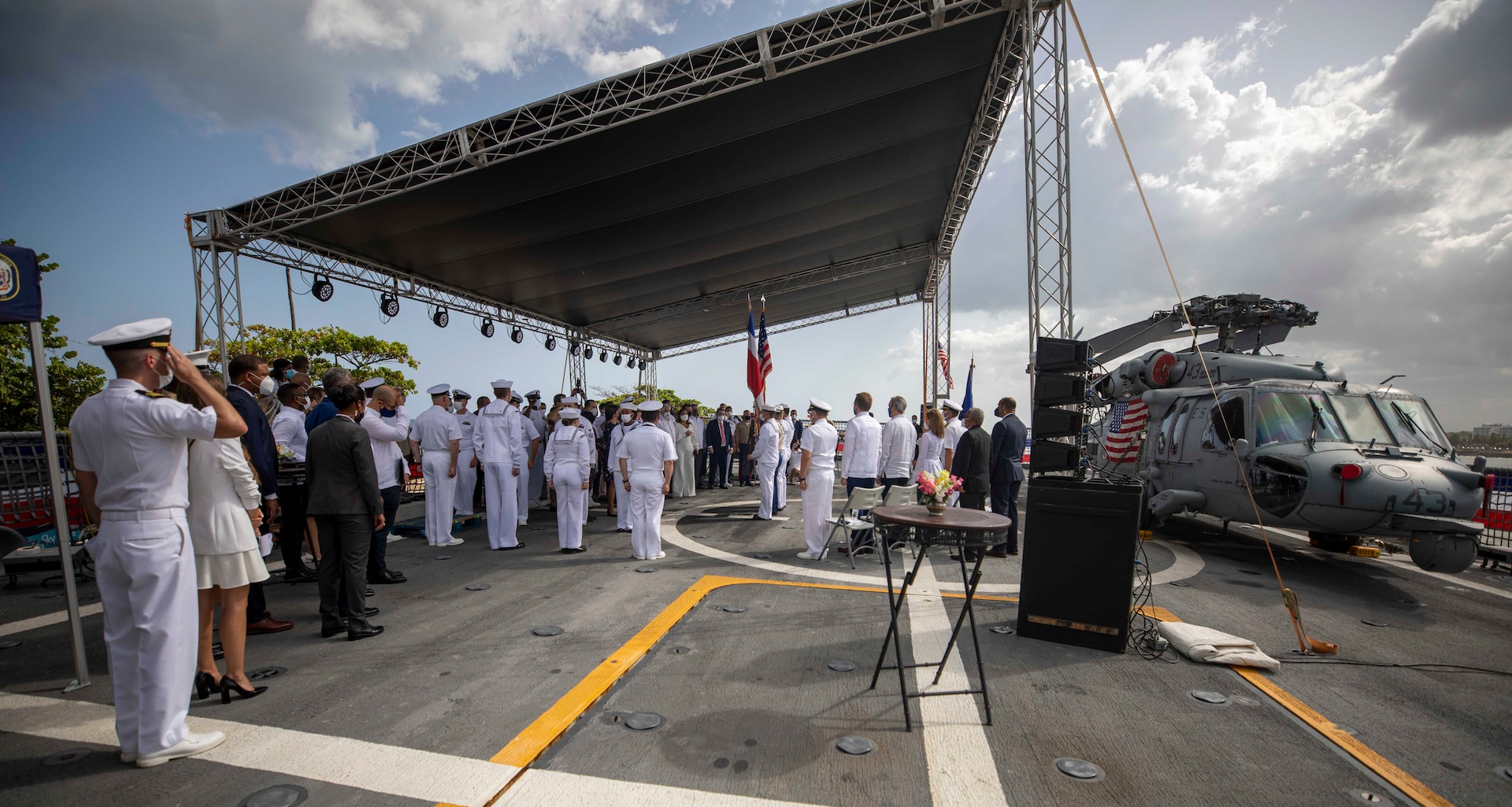 Honored guests stand for the U.S. national anthem during a reception on the flight deck aboard the Freedom-variant littoral combat ship USS Billings (LCS 15), July 9, 2021.