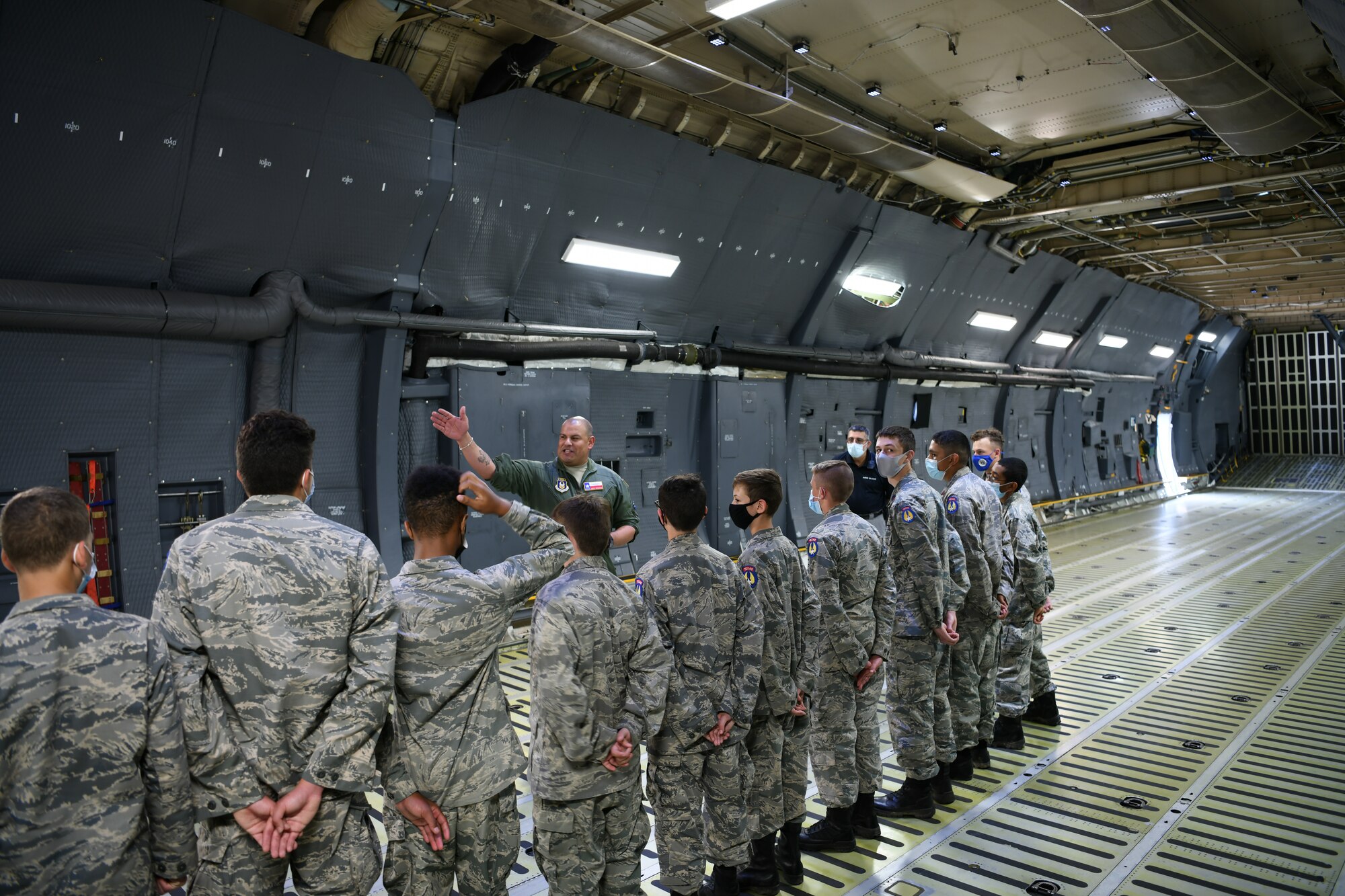Master Sgt. Eric Mungia, 68th Airlift Squadron loadmaster, talks to Texas Wing Civil Air Patrol cadets about the C-5M Super Galaxy aircraft at Joint Base San Antonio-Lackland, Texas, July 8, 2021. This visit promoted awareness of U.S. Air Force Reserve career options for the Cadets. (U.S. Air Force photo by Master Sgt. Kristian Carter)