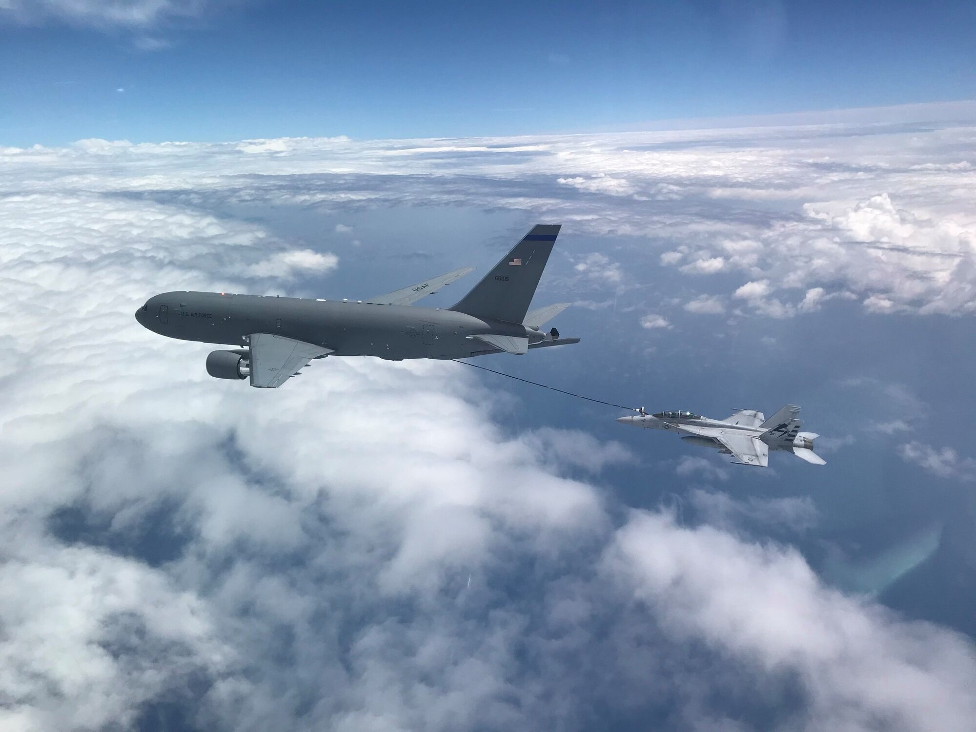 NH based KC-46A aircrew refuel a U.S. Navy F/A-18F Super Hornet off the coast of Maryland, July 1, 2020. This marked the first time the aircrew utilized the KC-46A centerline drogue system to refuel an aircraft. (Photo by Lt. Zach Fisher, U.S. Navy)