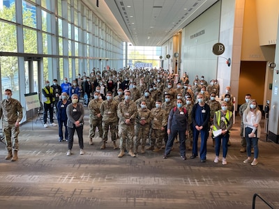 Group of medical personnel stand together.