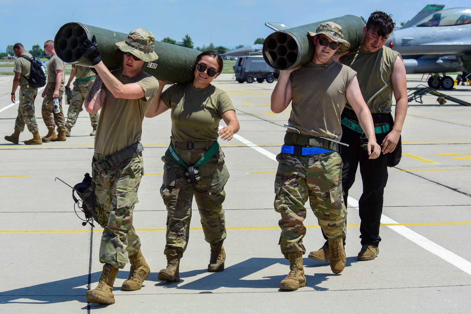 Four 555th Aircraft Maintenance Unit weapons load crew members carry an LAU-131 rocket pod after servicing a U.S. Air Force F-16 Fighting Falcon at Graf Ignatievo Air Base, Bulgaria, July 9, 2021. Thracian Star 21 missions will include offensive counter air and defensive counter air protection of high value assets, and close air support in a contested environment. (U.S. Air Force photo by Airman 1st Class Brooke Moeder)