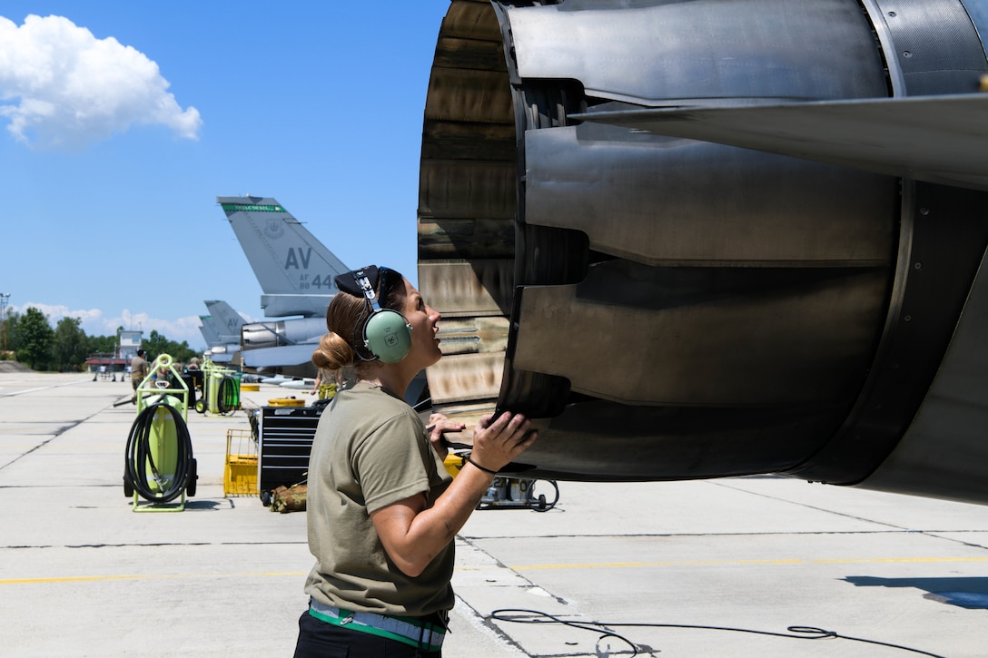 An F-16 Fighting Falcon crew chief assigned to the 555th Aircraft Maintenance Unit inspects a U.S. Air Force F-16 during exercise Thracian Star 21 at Graf Ignatievo Air Base, Bulgaria, July 9, 2021. Thracian Star 21 aims to enhance the ability to rapidly forward deploy, sustain operations, and work in coordination with partners and allies. (U.S. Air Force photo by Airman 1st Class Brooke Moeder)