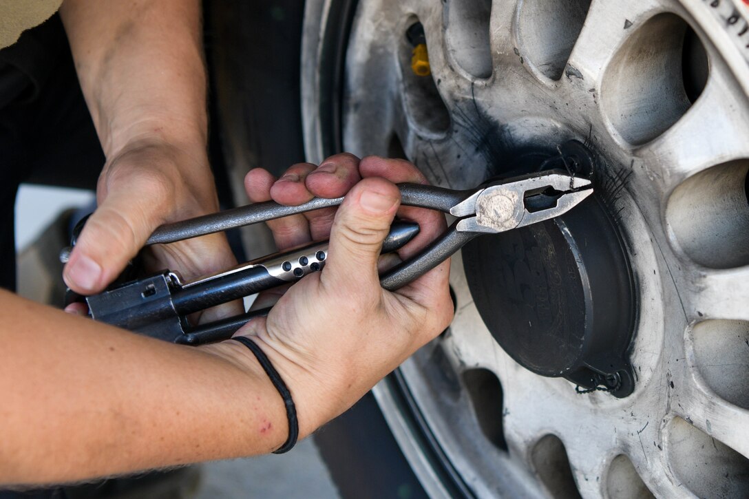 An F-16 Fighting Falcon crew chief assigned to the 555th Aircraft Maintenance Unit tightens a wire on a tire during exercise Thracian Star 21 at Graf Ignatievo Air Base, Bulgaria, July 9, 2021. Missions during Thracian Star 21 include offensive counter air and defensive counter air, protection of high value assets, and close air support in a contested environment. (U.S. Air Force photo by Airman 1st Class Brooke Moeder)