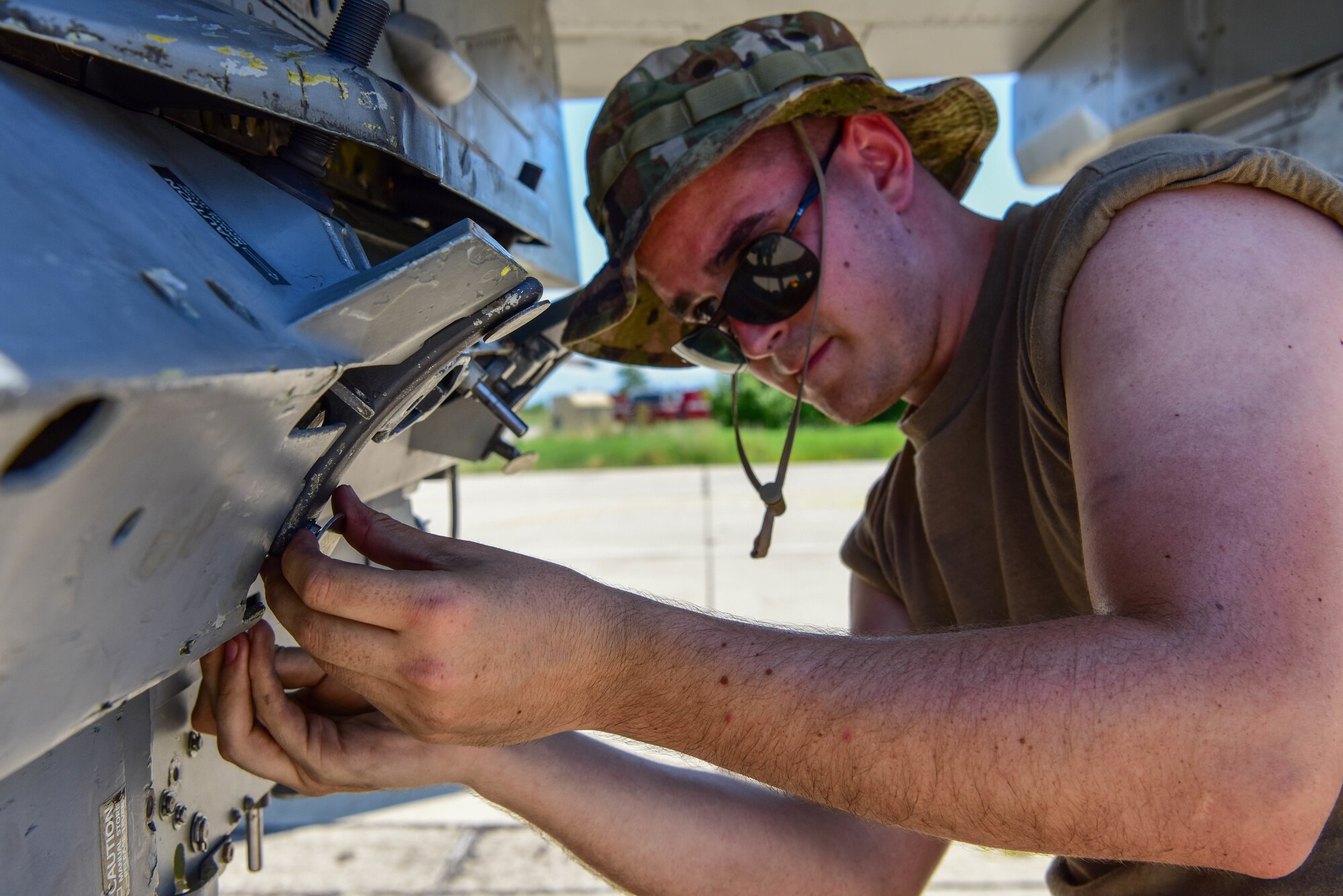 A  weapons load crew member assigned to the 555th Aircraft Maintenance Unit resets a triple ejector rack on a U.S. Air Force F-16 Fighting Falcon during Thracian Star 21 at Graf Ignatievo Air Base, Bulgaria, during exercise Thracian Star 21, July 9, 2021. Thracian Star 21 is a Bulgaria air force-led operational and tactical level live-fly field training exercise from July 9-23, 2021. (U.S. Air Force photo by Airman 1st Class Brooke Moeder)