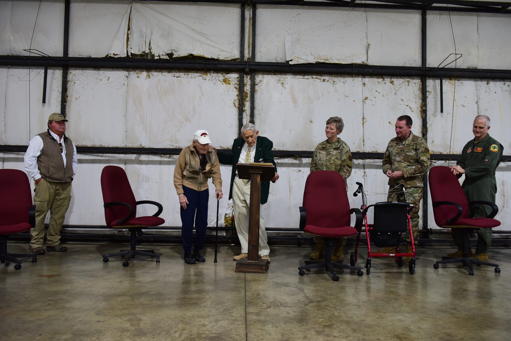 U.S. Air Force Lt. Col. (retired) Darrell Larkin stands to be coined by the Command Chief of the 178th Wing, Chief Master Sergeant Scott Ross, May 8, 2021 at the Highland County Airport, Hillsboro, Ohio. Larkin was a World War II Air Force pilot who has over 7,000 flying miles. (U.S. Air National Guard photo by Airman Jillian Maynus)