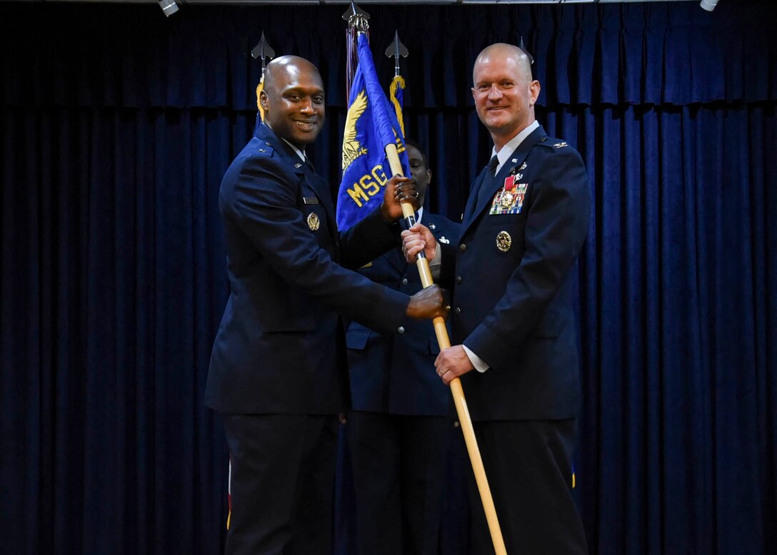 Brig. Gen. Kenyon K. Bell takes the guidon from Col. Joshua DeMotts