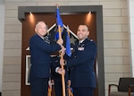 Col. Michael C. Brice, 433rd Medical Group commander, presents the 433rd Aerospace Medicine Squadron guidon to newly promoted Col. Luis A. Berrios during an assumption of command ceremony at Joint Base San Antonio-Lackland, Texas, July 10, 2021. A tradition in military heritage, passing the unit’s flag from one person to another signifies transfer of command. (U.S. Air Force photo by Tech. Sgt. Iram Carmona)