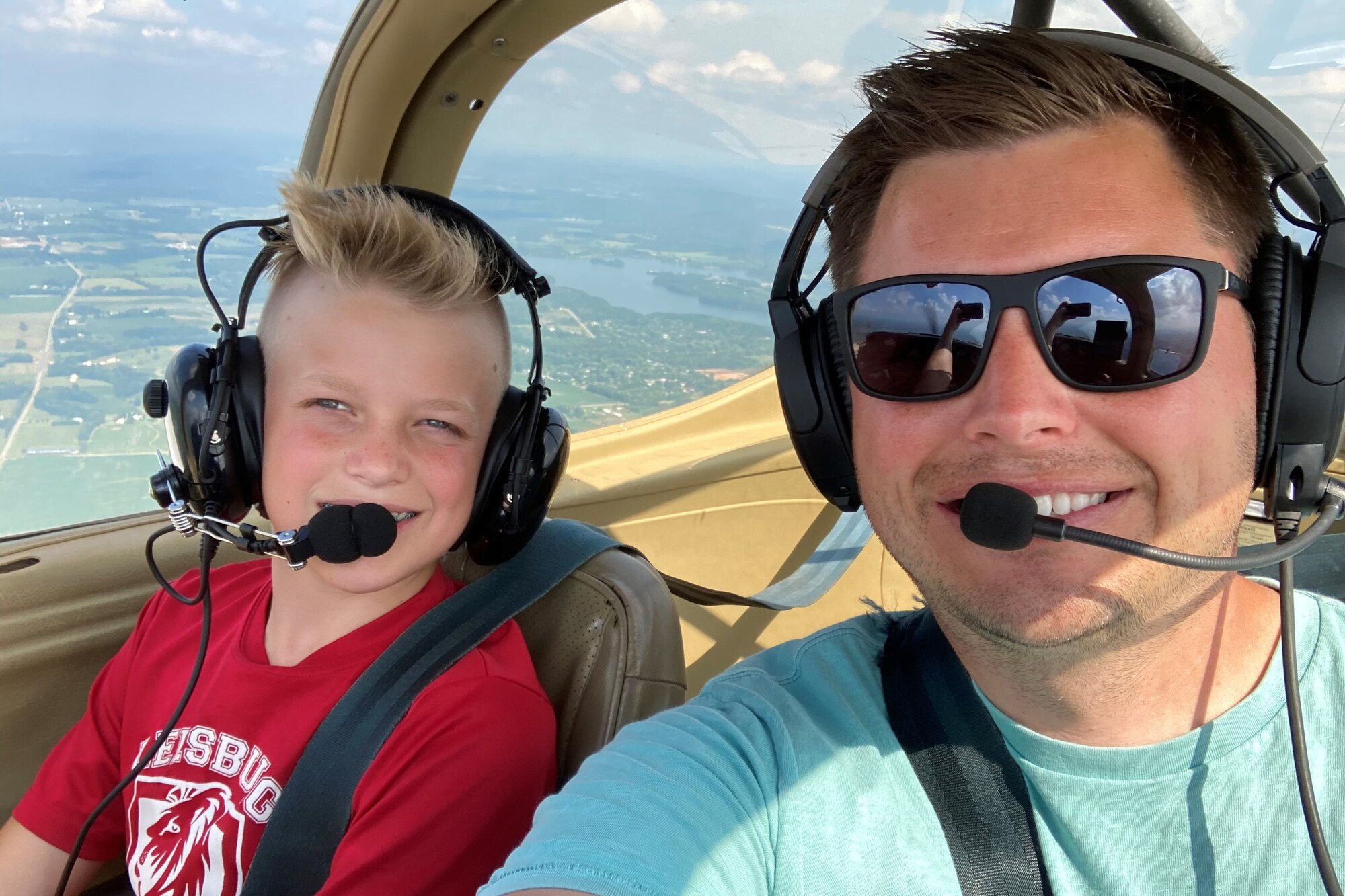 Tech. Sgt. Joshua Curtis, an Aviator assigned to the Ohio Air National Guard's 178th Wing in Springfield, Ohio, poses for a self-portrait with his nephew during a flight on his personal plane. He credited the training and job competencies he has learned in the Ohio Air National Guard for saving his nephew's life. (Courtesy photo)