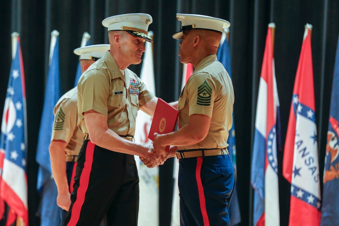 U.S. Marine Corps Maj. Gen. Jason Q. Bohm, the Commanding General of Marine Corps Recruiting Command (MCRC), congratulates Sgt. Major Cortez L. Brown, the out-going MCRC Sergeant Major, during the MCRC Sergeant Major relief and appointment ceremony at Little Hall, Marine Corps Base Quantico, Va., July 9, 2021. During the ceremony, Sgt. Maj. Cortez L. Brown was relieved as the MCRC Sergeant Major while Sgt. Maj. Adan F. Moreno was appointed as the new MCRC Sergeant Major.  (U.S. Marine Corps photo by Lance Cpl. Jennifer Sanchez)