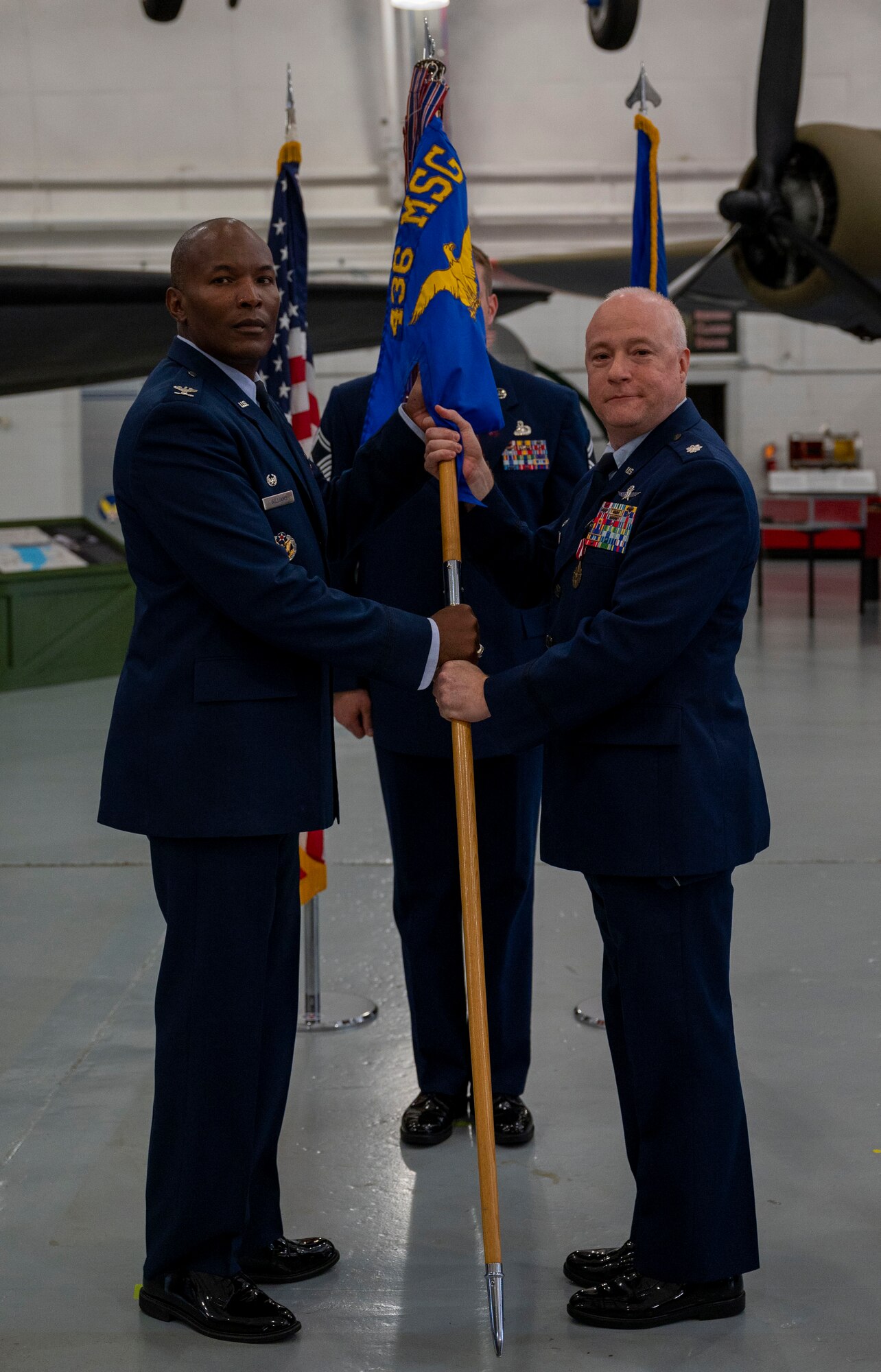 Col. Phelemon Williams, left, 436th Mission Support Group commander, accepts the 436th Communications Squadron guidon from Lt. Col. Peter Dell’Accio, outgoing 436th CS commander, during a change of command ceremony at Dover Air Force Base, Delaware, July 9, 2021. During the ceremony, Dell’Accio relinquished command to Lt. Col. Shawn Crowe. The 436th CS plans, installs, operates and maintains $75 million in command, control, communications, computer and visual information systems. (U.S. Air Force photo by Airman 1st Class Cydney Lee)