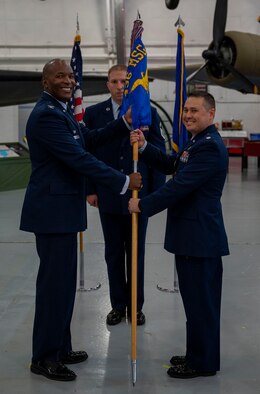 Col. Phelemon Williams, left, 436th Mission Support Group commander, passes the 436th Communications Squadron guidon to Lt. Col. Shawn Crowe, 436th CS commander, during a change of command ceremony at Dover Air Force Base, Delaware, July 9, 2021. During the ceremony, Crowe took command from Lt. Col. Peter Dell’Accio. The 436th CS plans, installs, operates and maintains $75 million in command, control, communications, computer and visual information systems. (U.S. Air Force photo by Airman 1st Class Cydney Lee)