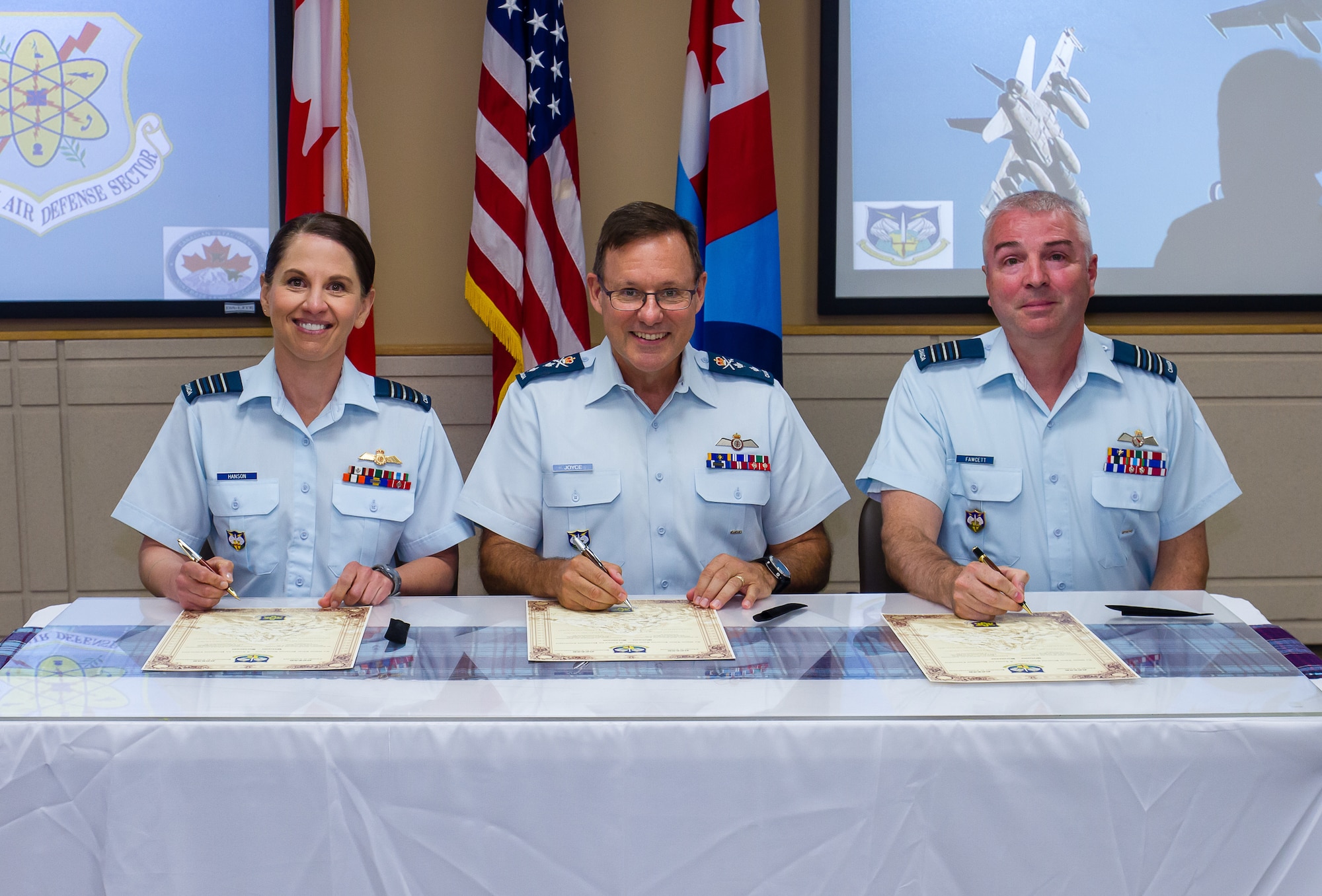 picture of the new Canadian Detachment Commander signing the scrolls.