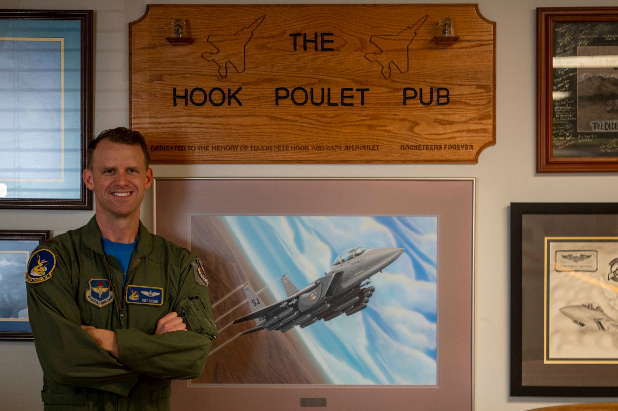 Maj. David Hook, 50th Flying Training Squadron instructor pilot, stands beside a sign in the 336th Fighter Squadron at Seymour Johnson Air Force Base, North Carolina, July 9, 2021.