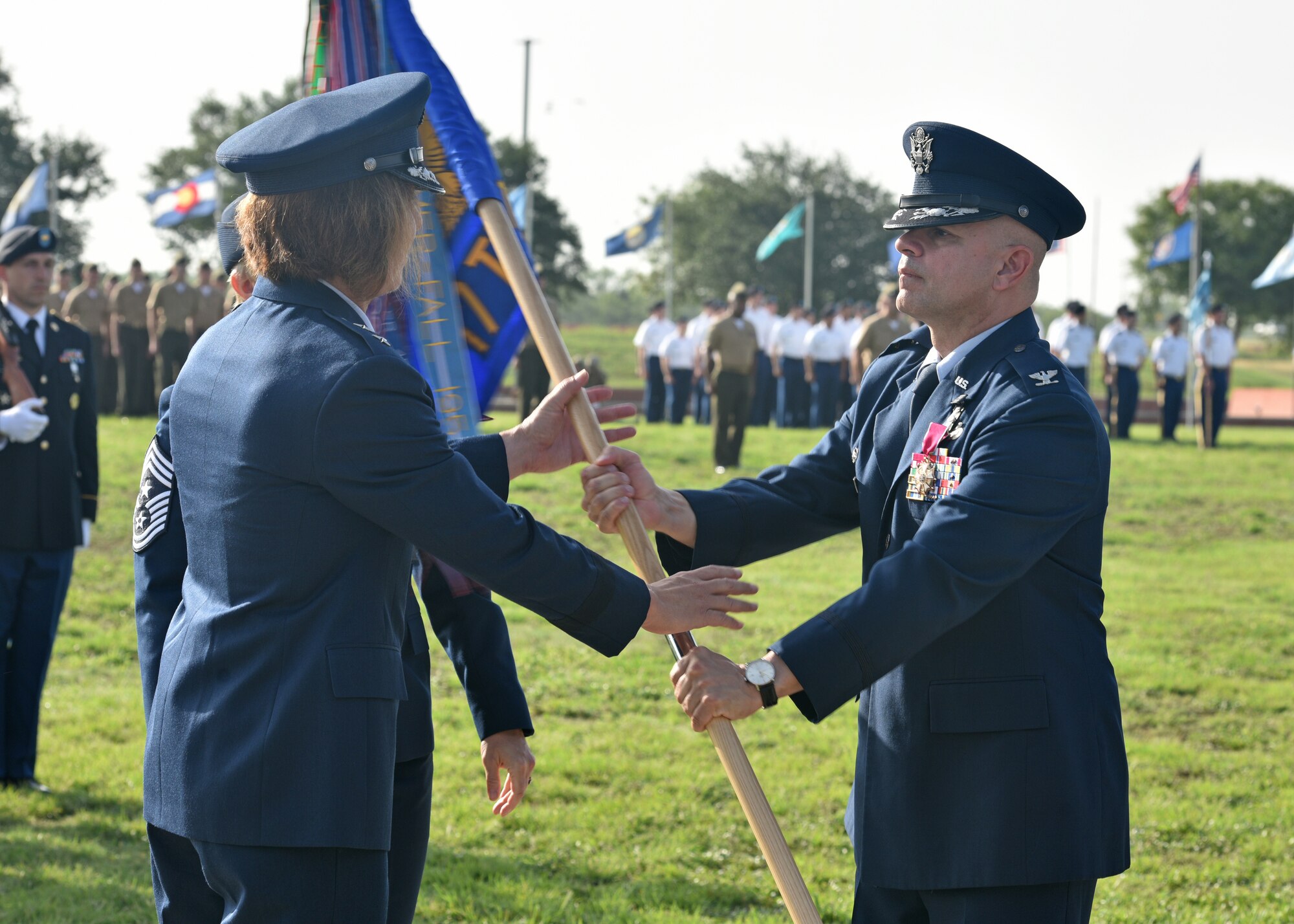 U.S. Air Force Col. Andres Nazario, 17th Training Wing outgoing commander, relinquishes command to Maj. Gen. Andrea Tullos, Second Air Force commander, during the 17th TRW change of command ceremony on Goodfellow Air Force Base, Texas, July 13, 2021. During his time here, Nazario created The Goodfellow Way, a new strategic approach fueled by vision, leadership and energy to improve the way of life for the Goodfellow community.  (U.S. Air Force photo by Senior Airman Ashley Thrash)