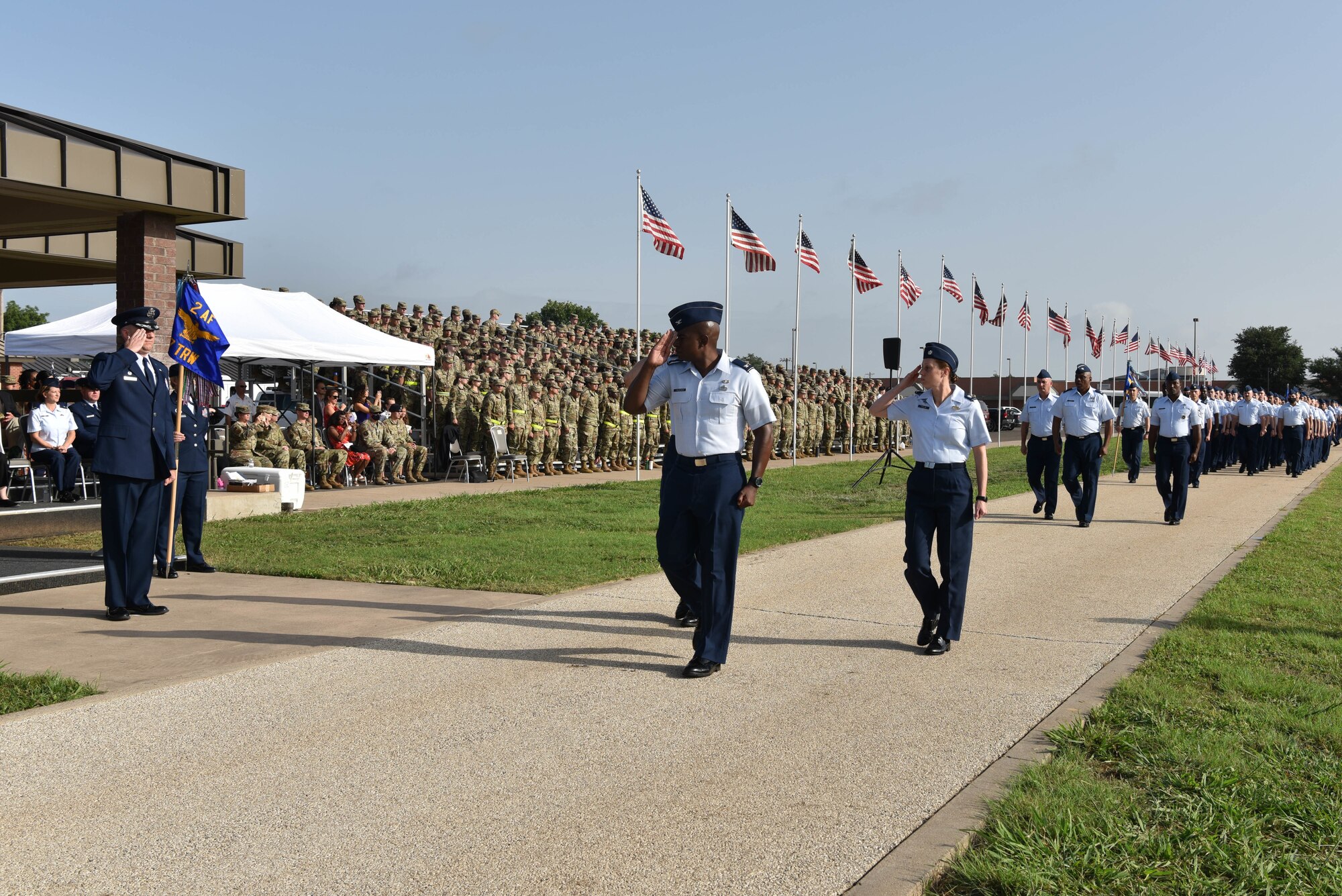 U.S. Air Force Col. Matthew Reilman, 17th Training Wing commander, salutes Col. James Finlayson, 17th TRW vice commander, and members of the 17th TRW during the pass in review portion of the change of command ceremony on Goodfellow Air Force Base, Texas, July 13, 2021. The 17th TRW change of command ceremony commenced at the traditional time of 8:17 a.m. (U.S. Air Force photo by Senior Airman Jermaine Ayers)