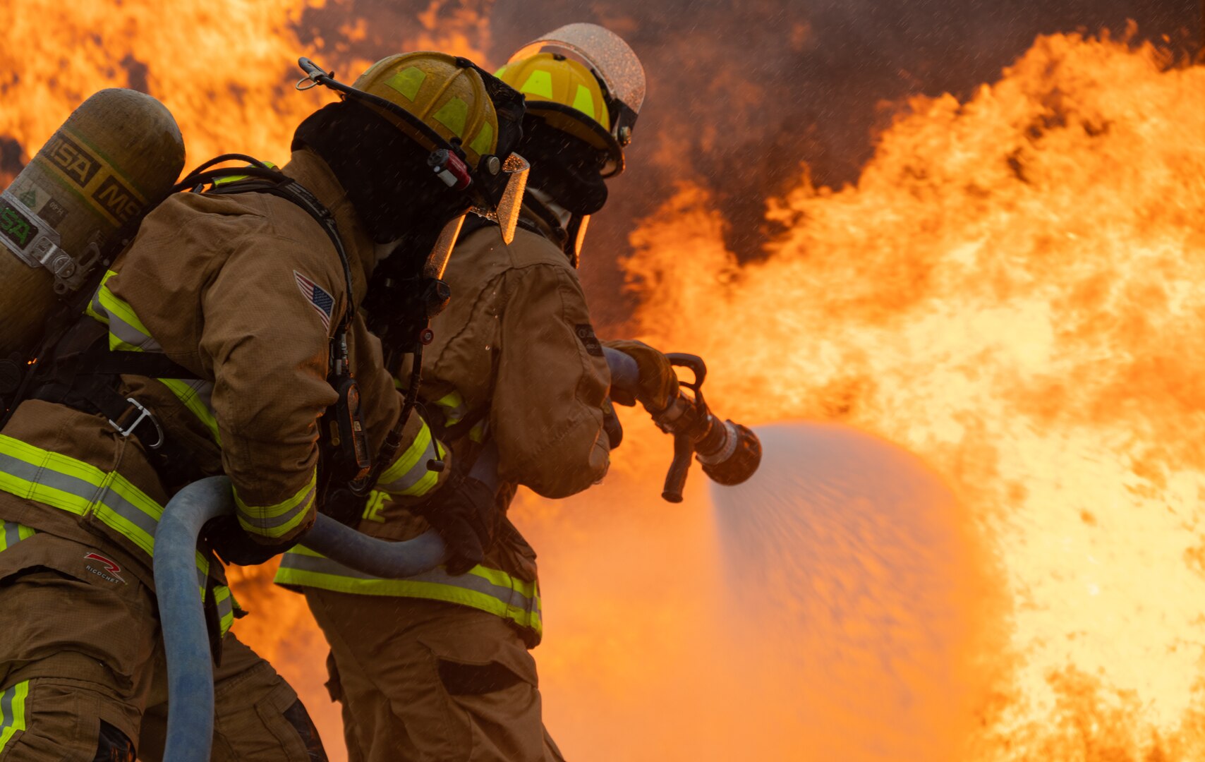Fire protection specialists with the 152nd Civil Engineer Squadron, Nevada Air National Guard, extinguish an exterior fire of a C-130 aircraft frame during a live-burn exercise at Volk Field Air National Guard Base in Wisconsin July 7, 2021.