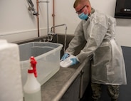 U.S. Air Force Airmen Logan Abell from the 158th Fighter Wing, Vermont Air National Guard, sanitizes coolers used at the Strategic National Stockpile Warehouse, August 27, 2020, the coolers are used to transport completed COVID-19 test kits to the lab and after sanitation are reused to send with newly assembled test kits. Airmen from across the 158th Fighter Wing have supported operations at the SNS Warehouse since March 2020, and continue to provide critical logistical support to enable Vermont's efforts to distribute Personal Protective Equipment throughout the state and conduct widespread testing for COVID-19. (U.S. Army National Guard photo by Capt. J. Scott Detweiler)