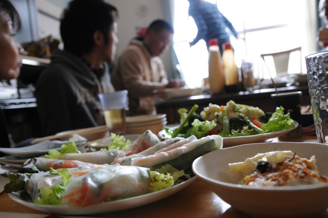 Military personnel enjoy traditional Japanese cuisine during a visit to the home of Maj. Yasuo Okamoto of the Japan Ground Self Defense Force, Jan. 29.