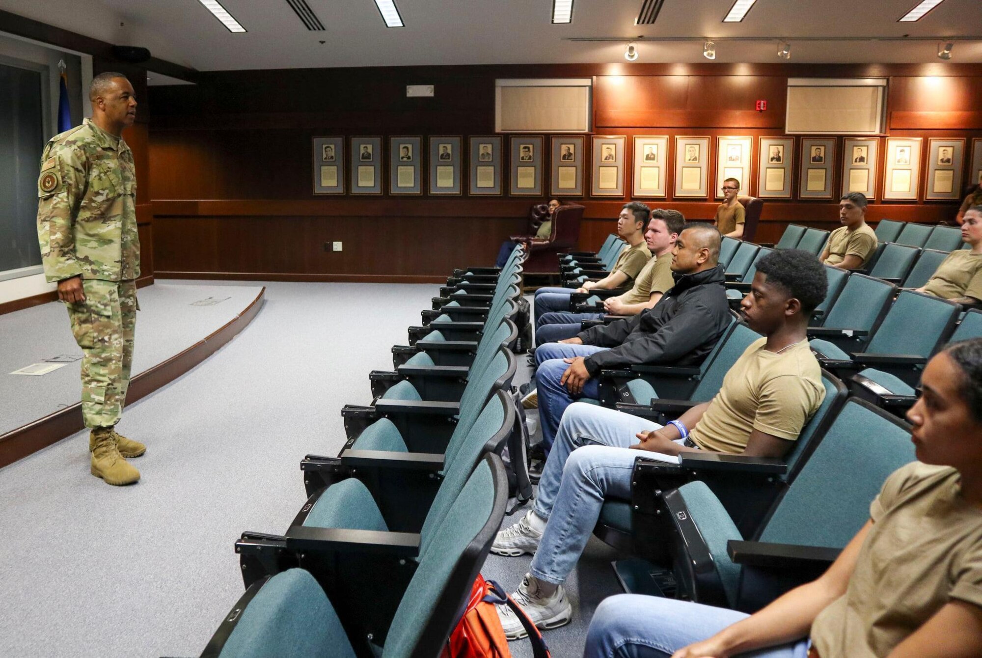 Air Force Reserve Command Chief talks to new recruits in an auditorium