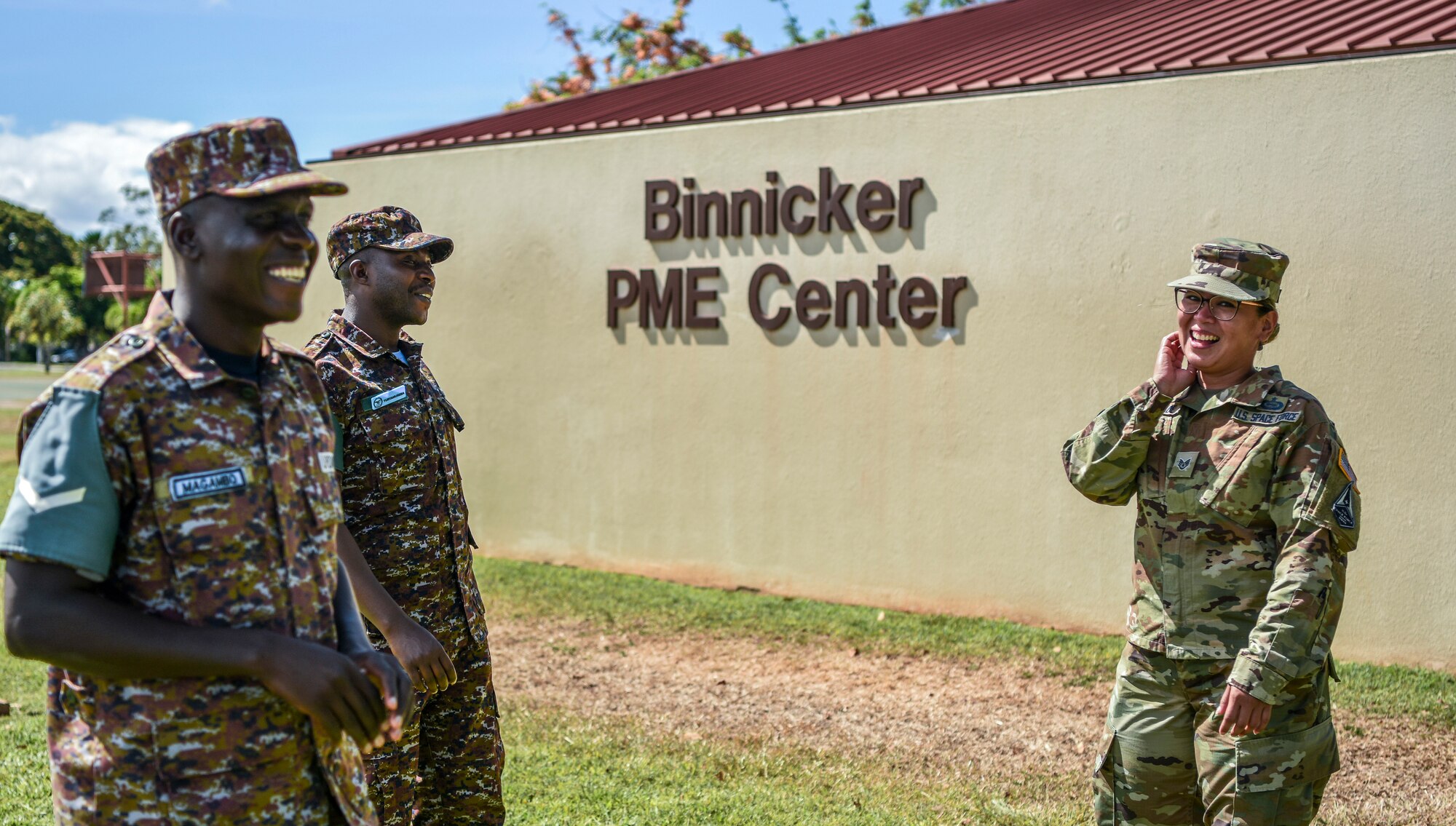 U.S. Space Force Sgt. Carol Grande and Ugandan Air Force Sgts. Turyamureba Daniel and Magambo Charles share a laugh between classes at Joint Base Pearl Harbor-Hickam, Hawaii, June 28, 2021. Grande, Daniel, and Charles recently graduated Airman Leadership School from the Chief Master Sgt. James C. Binnicker Professional Military Education Center.

(U.S. Air Force photo by Tech. Sgt. Anthony Nelson Jr.).