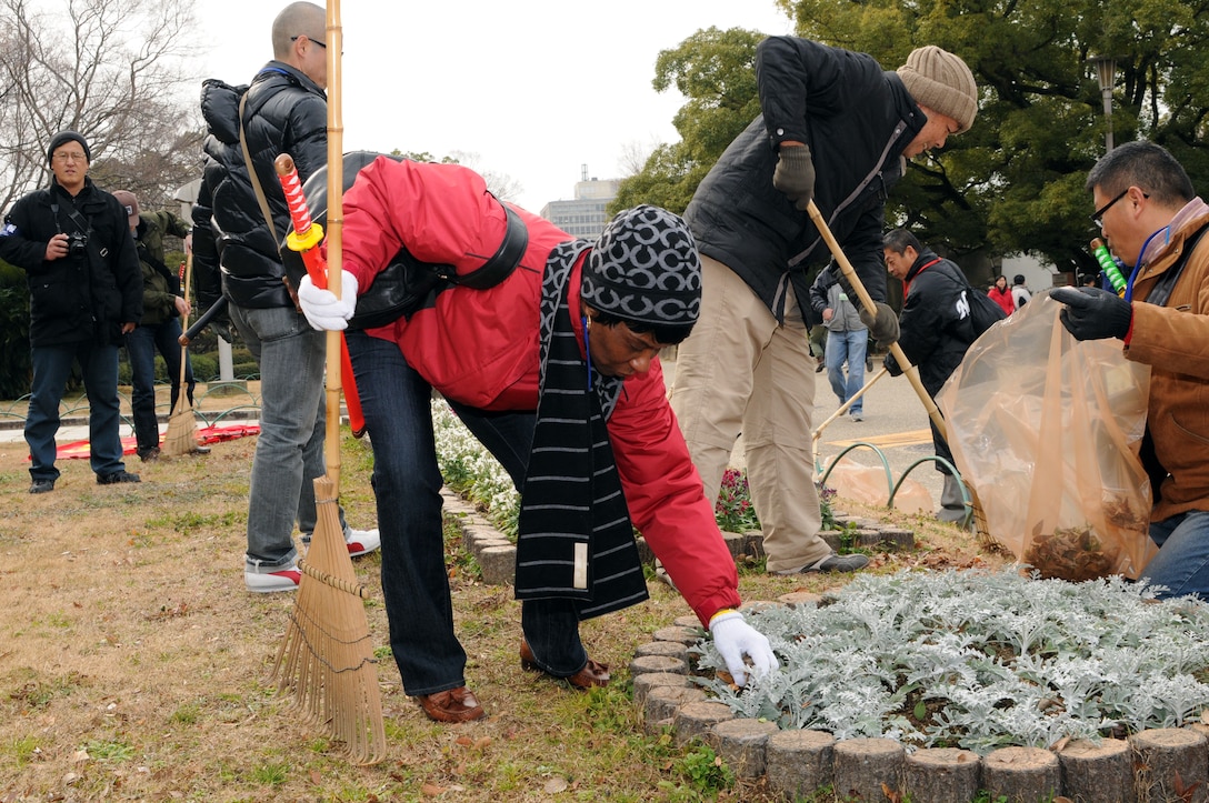 Command Sgt. Maj. Mary L. Brown, battalion command sergeant major for HHBN, U.S. Army Pacific, based at Fort Shafter, Hawaii, greets participant Yoshiko Fujii during the cleanup of the Osaka Castle grounds Jan. 28.