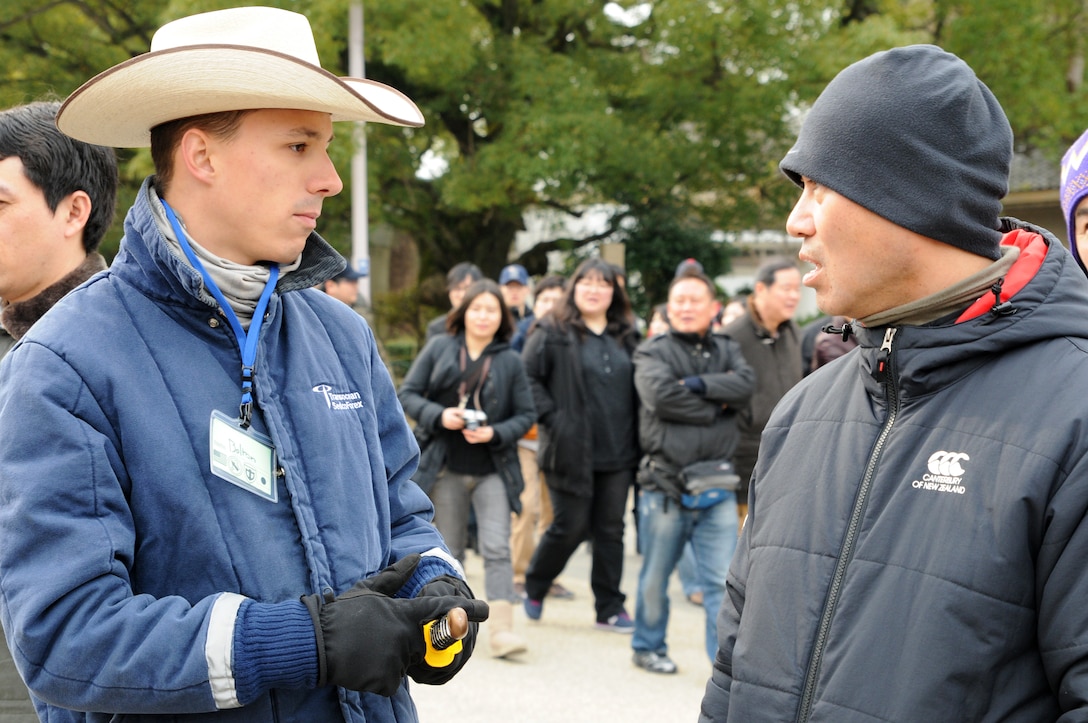 Command Sgt. Maj. Mary L. Brown, battalion command sergeant major for HHBN, U.S. Army Pacific, based at Fort Shafter, Hawaii, greets participant Yoshiko Fujii during the cleanup of the Osaka Castle grounds Jan. 28.