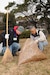 Spc. Isaac J. Ferderer, battle radio transmitter operator for the 34th Infantry Division, Minnesota National Guard, assists a member of the Japan Ground Self-Defense Force during a cleanup of Osaka Castle in Osaka, Japan Jan. 28.