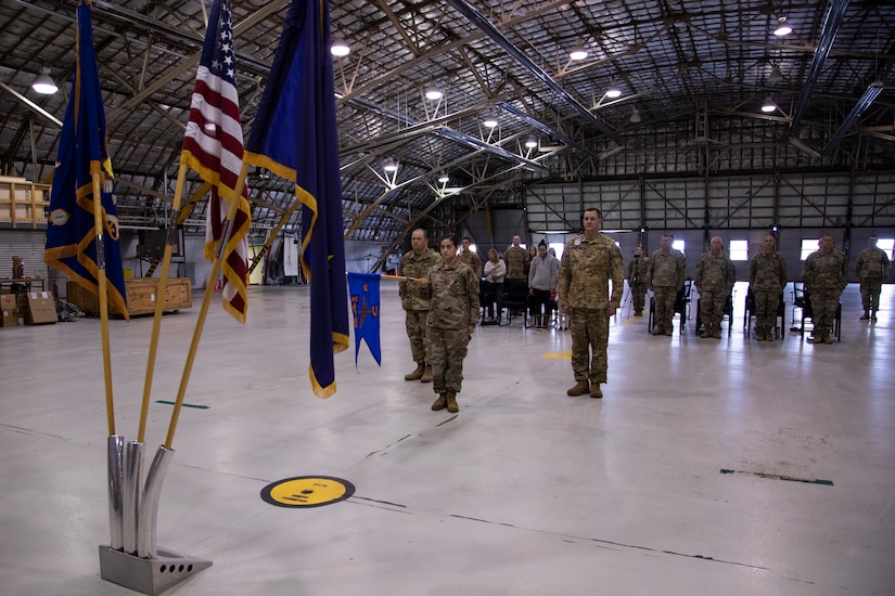 Soldiers from the 2nd Battalion, 641st Aviation Regiment stand for the National Anthem during a casing ceremony at the unit's aircraft hangar on Joint Base Elmendorf-Richardson, July 9, 2021. The traditional casing ceremony was held as the unit prepares to leave for the mobilization station at Fort Bliss, Texas, prior to deployment overseas. (U.S. Army National Guard photo by Victoria Granado)