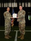 U.S. Air Force Col. Stuart Williamson, the 354th Mission Support Group commander (left), and Maj. Paul Carico, former 354th Communications Squadron (CS) commander, pose for a photo during a change of command ceremony on Eielson Air Force Base, Alaska, July 9, 2021.